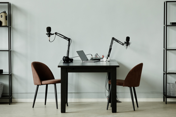 Podcast recording setup with two chairs and microphones