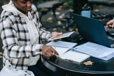 black woman with tablet taking notes